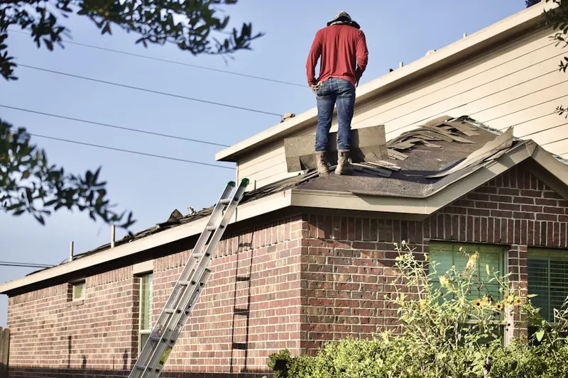 Professional roofer working on a residential roof in Schriever